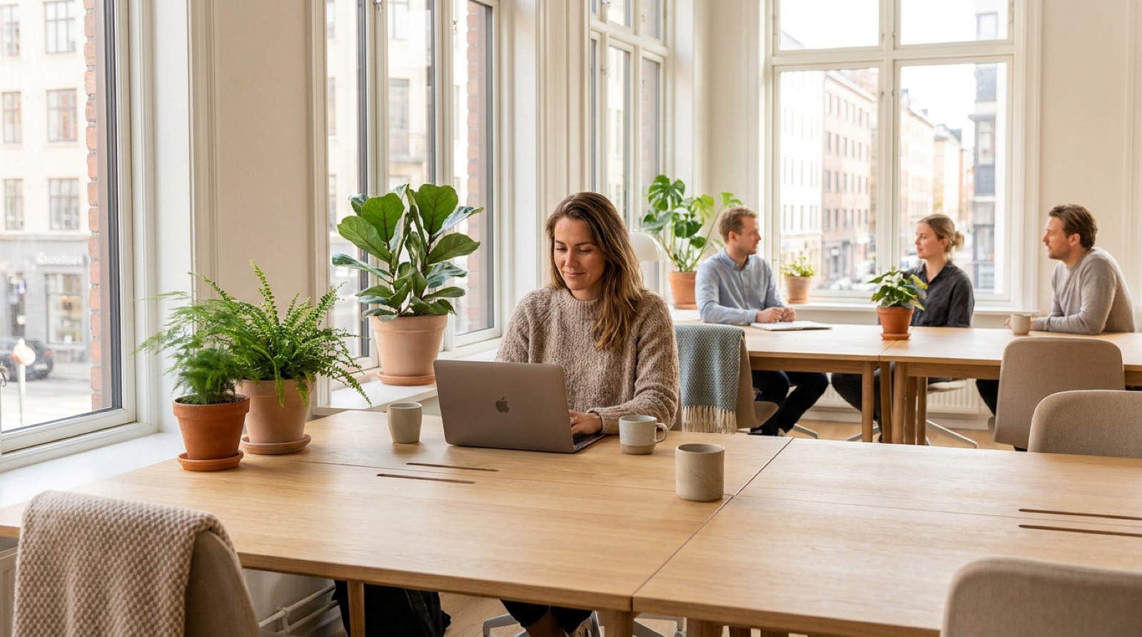 Recruiters working calmly in a bright Nordic staffing agency office